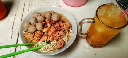 Chicken noodles meatballs and orange juice. Top view photo
