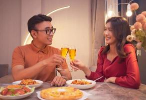 Young Asian couple eating dinner together photo