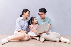 Young Asian family sitting on the floor photo