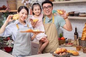 Young Asian family in the kitchen photo