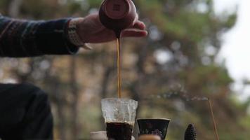 tea master pours pu-erh tea into a glass video