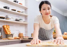 Young Asian woman cleaning the kitchen after cooking photo