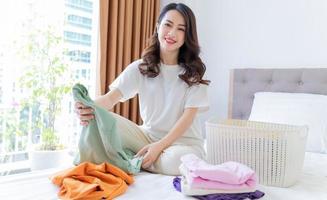 Young Asian woman folding clothes photo