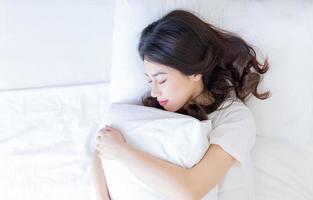 Young Asian woman sleeping on bed photo