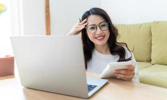 Young Asian woman working at home photo