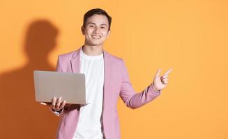 Portrait of young Asian man posing on background photo