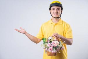 Image of young Asian delivery man on background photo