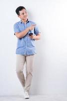 Full length image of young Asian man on white background photo