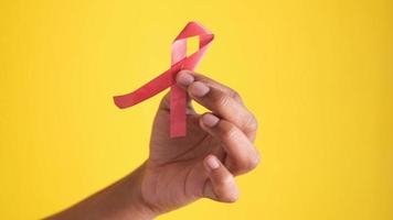 Hand Holding Red Ribbon Hiv With Copy Space video