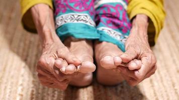 Close up on senior woman massaging her feet on injury spot video