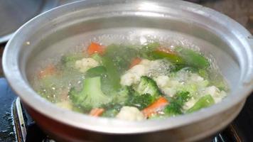 Cooking fresh vegetables in a pan, top view , video