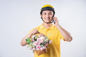 Image of young Asian delivery man on background photo