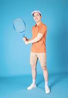 Image of young Asian man holding tennis racket photo