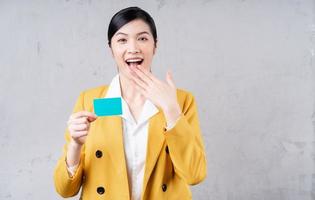 Image of young Asian woman holding bank card photo