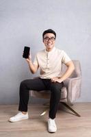 Image of young Asian man sitting on chair photo