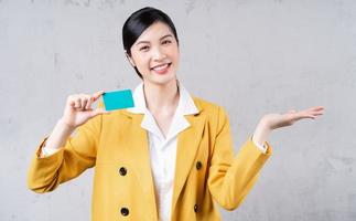 Image of young Asian woman holding bank card photo