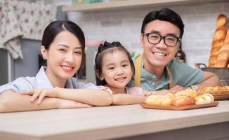 Young Asian family in the kitchen photo