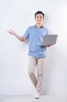 Full length image of young Asian man on white background photo