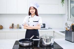 Image of young Asian woman chef in the kitchen photo