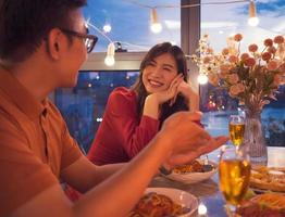 Young Asian couple eating dinner together photo