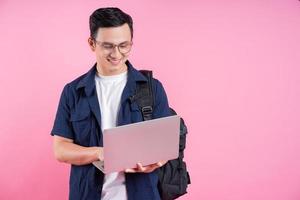 Image of young Asian college student on pink background photo