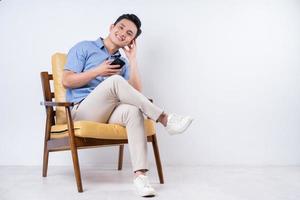 Image of young Asian man sitting on chair photo