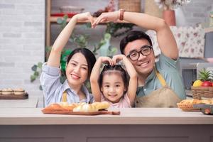Young Asian family in the kitchen photo