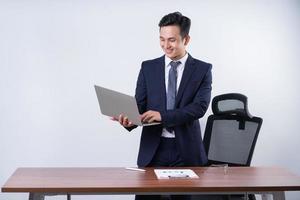 Image of young Asian businessman on background photo