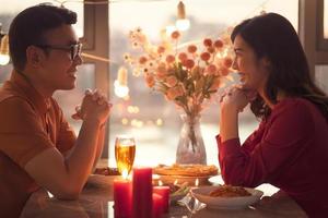 Young Asian couple eating dinner together photo