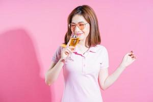 Photo of young Asian girl posing on pink background