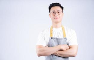 Image of young Asian waiter on background photo