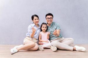 Young Asian family sitting on the floor photo