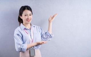 Image of young Asian employee on background photo