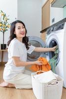 Image of Young Asian woman washing clothes photo