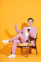 Image of young Asian man sitting on chair photo