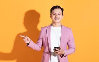 Portrait of young Asian man posing on background photo