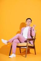 Image of young Asian man sitting on chair photo