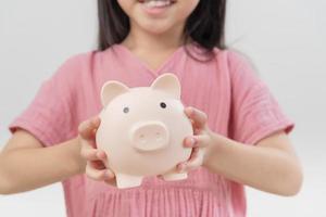 girl hands hold a pink piggy bank . The concept of saving money or savings, investment photo