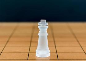 Chess glass on a wood chessboard photo