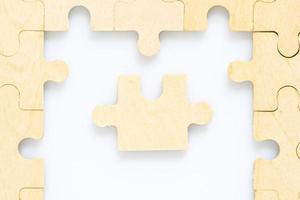 wooden jigsaw puzzle pieces on white background photo