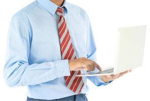 Businessman holding a laptop with clipping path photo