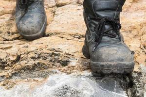 Trekking leather boot on the rock photo