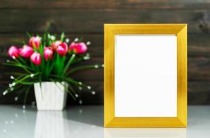 Picture mock up with golden frame on table photo