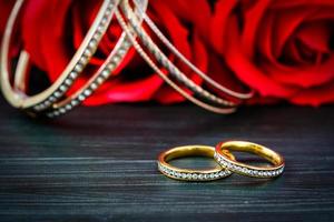 Gold wedding rings with diamond and rose flower photo