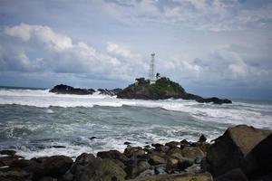 lighthouse landscape and wave on the beach photo