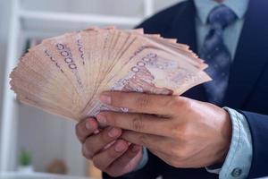 Business men are counting a lot of 1000 baht each banknote Thai currency concept. photo