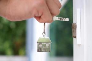 Landlord unlocks the house key for new home photo