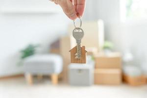 Moving house, relocation. Woman hold key house keychain in new apartment. move in new home. Buy or rent real estate. flat tenancy, leasehold property, new landlord, dwelling, loan, mortgage. photo