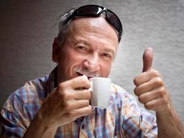 Good coffee. Senior man portrait photo