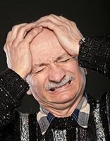 Headache. Senior man portrait photo